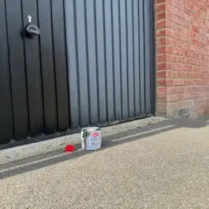 Before and after Polytrol on a black garage door