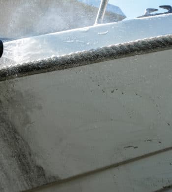 Rinsing off Owaclean from a boat gelcoat