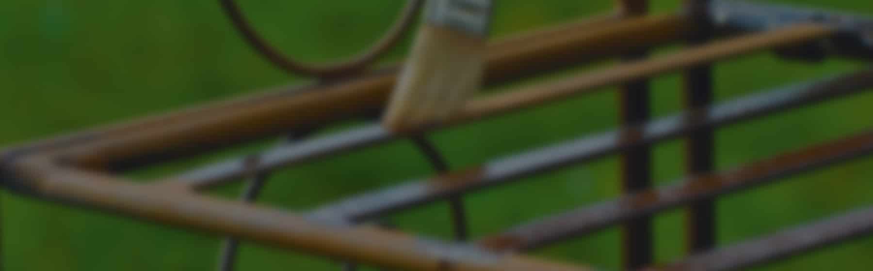 A person brushing oil onto metal with a paint brush