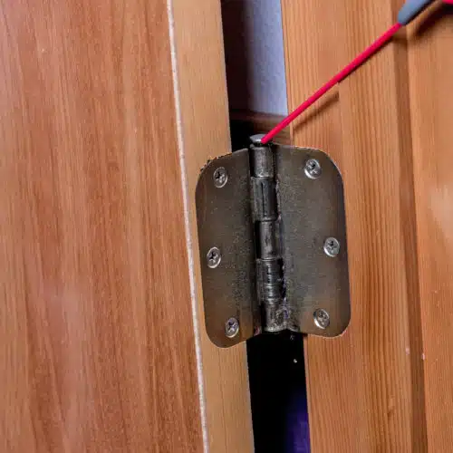 Oil being applied to a hinge