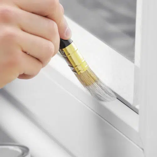 Close up of a upvs window frame being painted