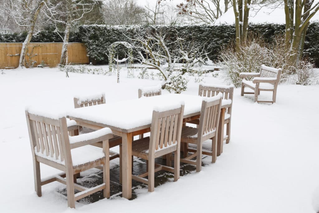 Garden furniture covered in snow