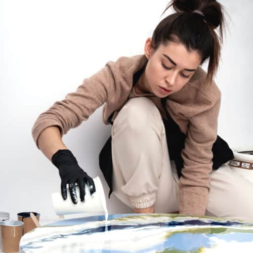 Person creating a fluid art painting.