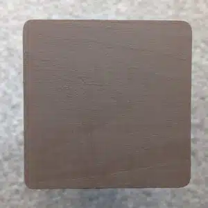 Dark Brown Decking Paint swatch - applied to new pine wood in natural lighting.