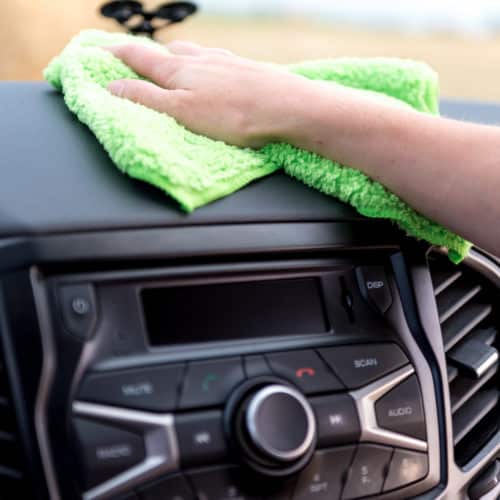 Using a microfibre cloth on a car dashboard