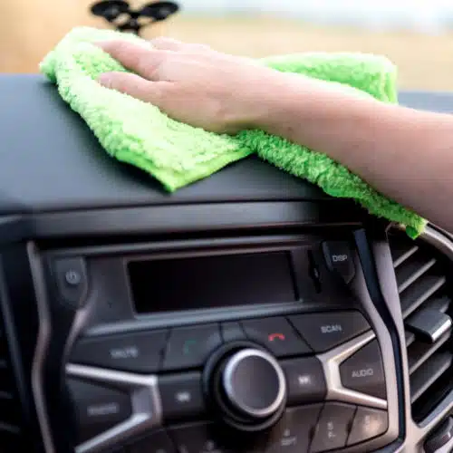 Using a microfibre cloth on a car dashboard