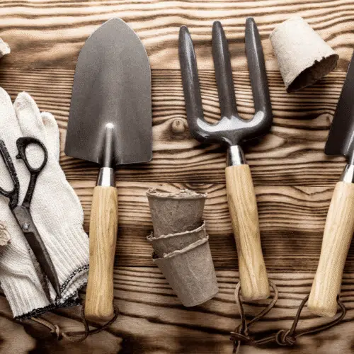 various garden tools on wooden table